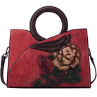 Red handbag with floral design and brown handle on a white background