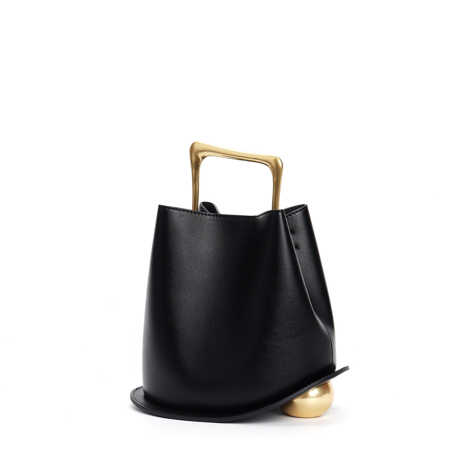 Black handbag with a gold handle and base on a white background