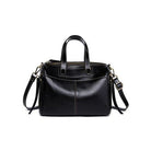Black handbag with a strap on a white background