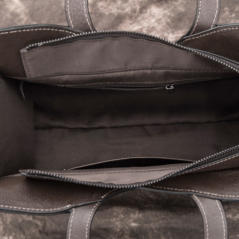 Close-up of a brown leather bag with visible stitching details.