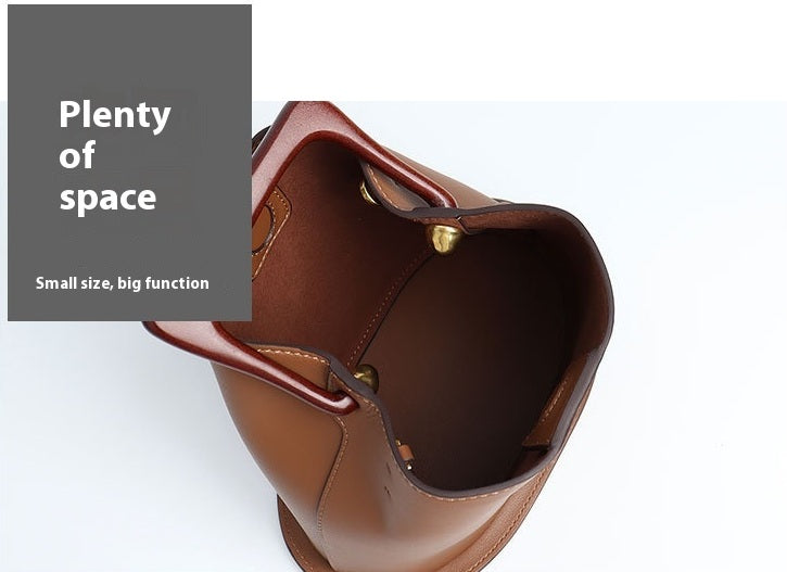 Brown leather bag with open top showing 'Plenty of space' text on a white background
