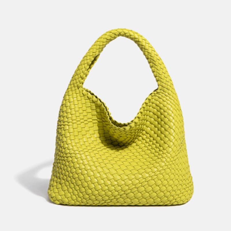 Yellow woven handbag on a light gray background
