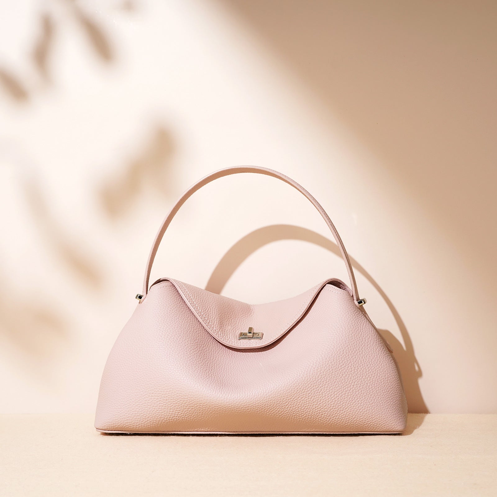 Pink handbag on a beige background