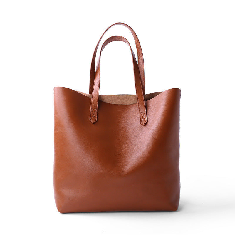 Brown leather tote bag on a white background