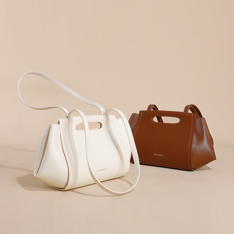 White and brown handbags on a beige background