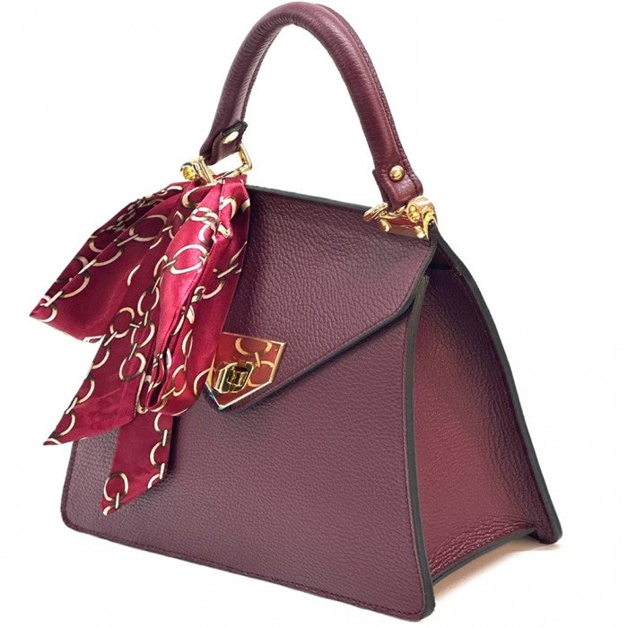 Burgundy handbag with a matching scarf on a white background