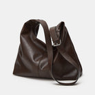 Brown leather handbag on a light gray background