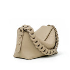 Beige handbag with braided chain strap on a white background