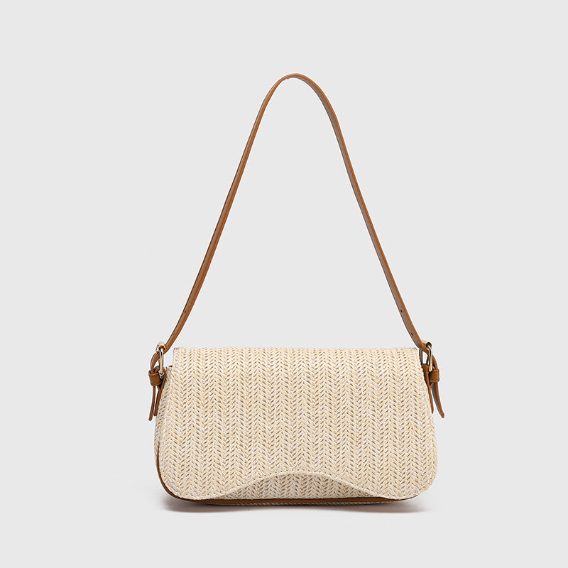 Woven handbag with a brown strap on a light gray background