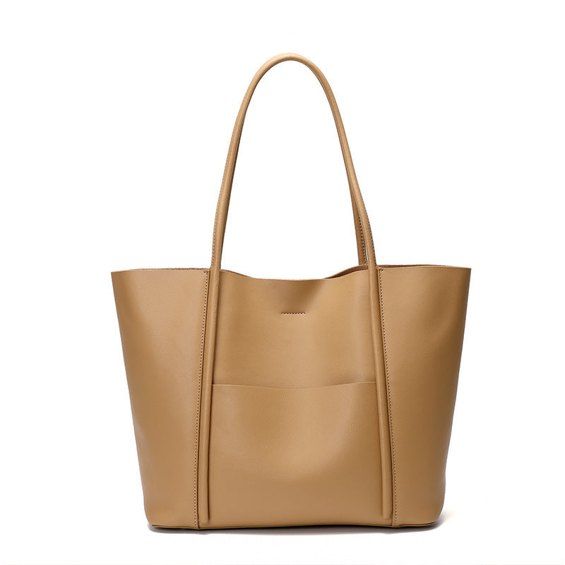 Tan leather tote bag on a white background