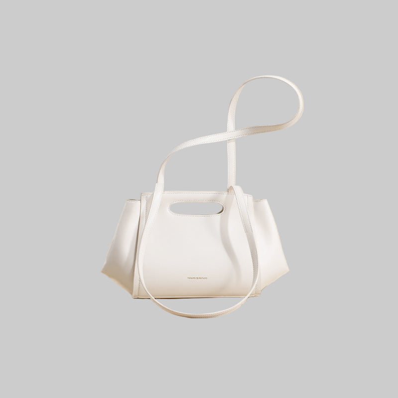 White handbag with a strap on a beige background