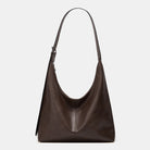 Brown leather handbag on a light gray background