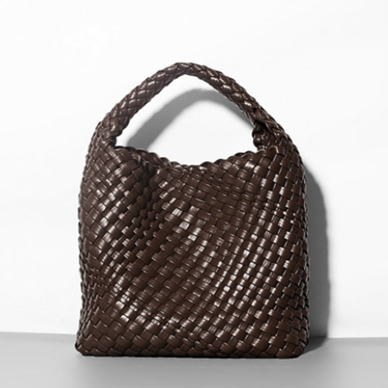 Brown woven handbag on a white background