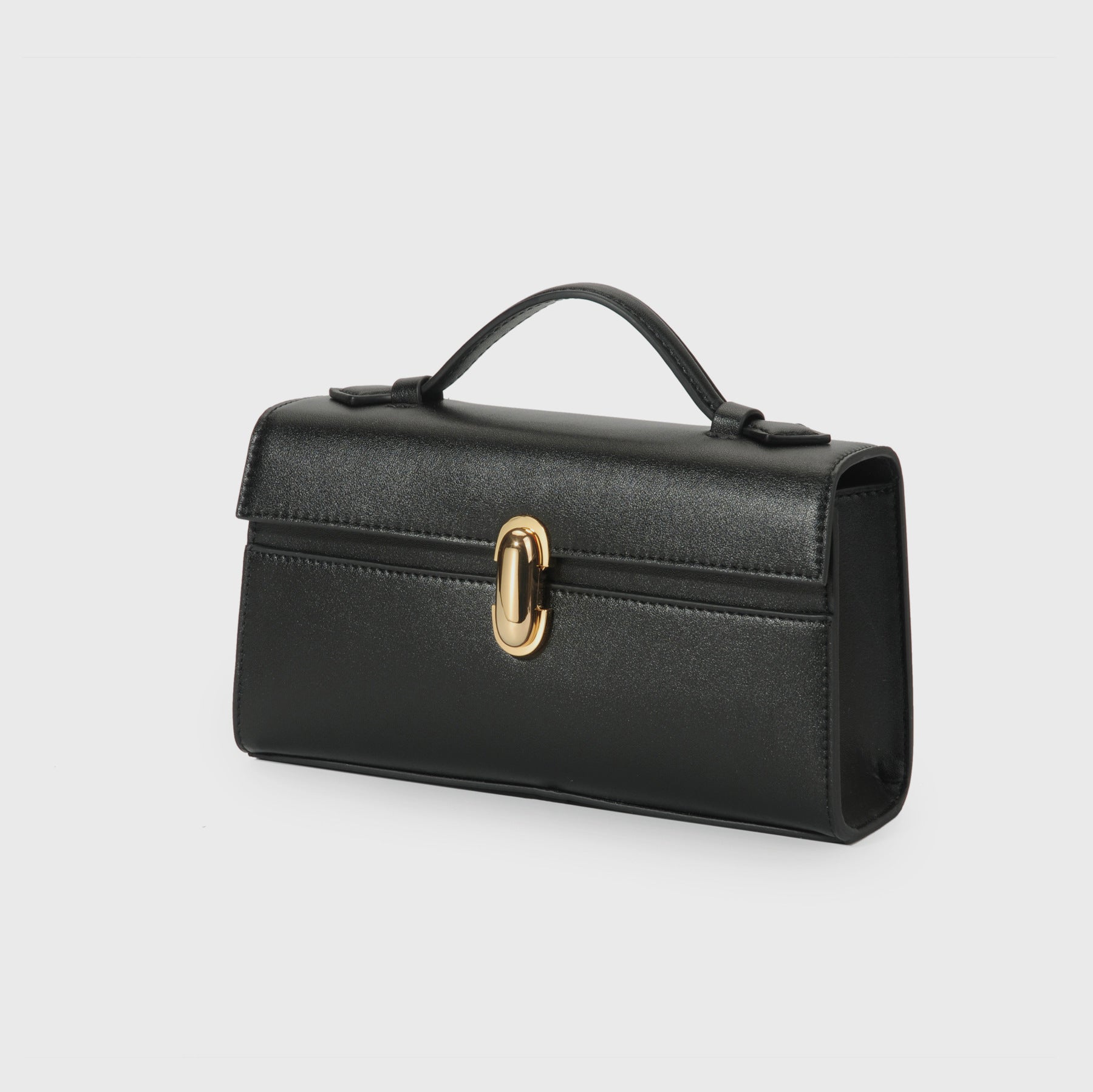 Black handbag with a gold clasp on a light gray background