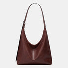 Brown leather handbag on a light gray background