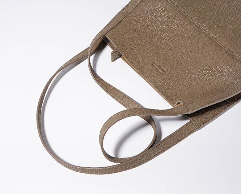 Beige handbag with a strap on a white background