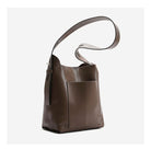 Brown leather handbag with a strap on a white background