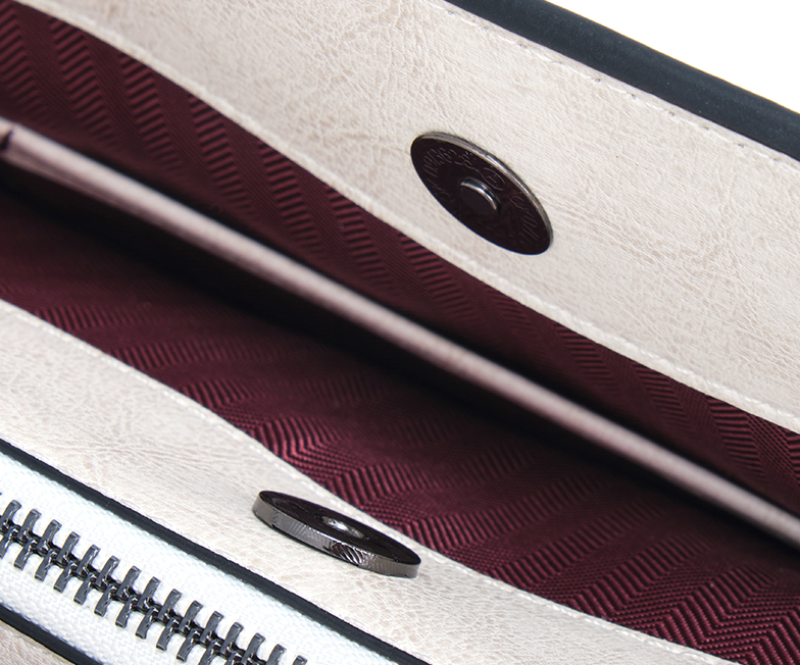 Close-up of a textured surface with a zipper and metallic handle.