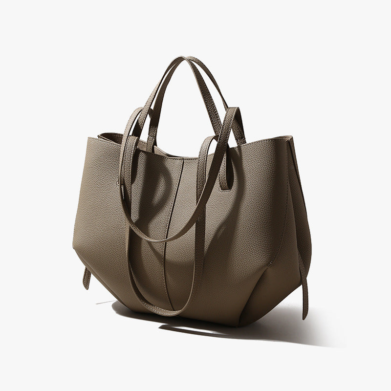 Brown leather handbag on a white background