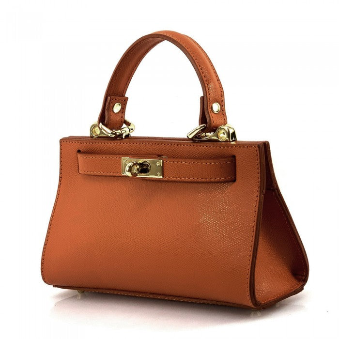 Brown handbag with gold accents on a white background