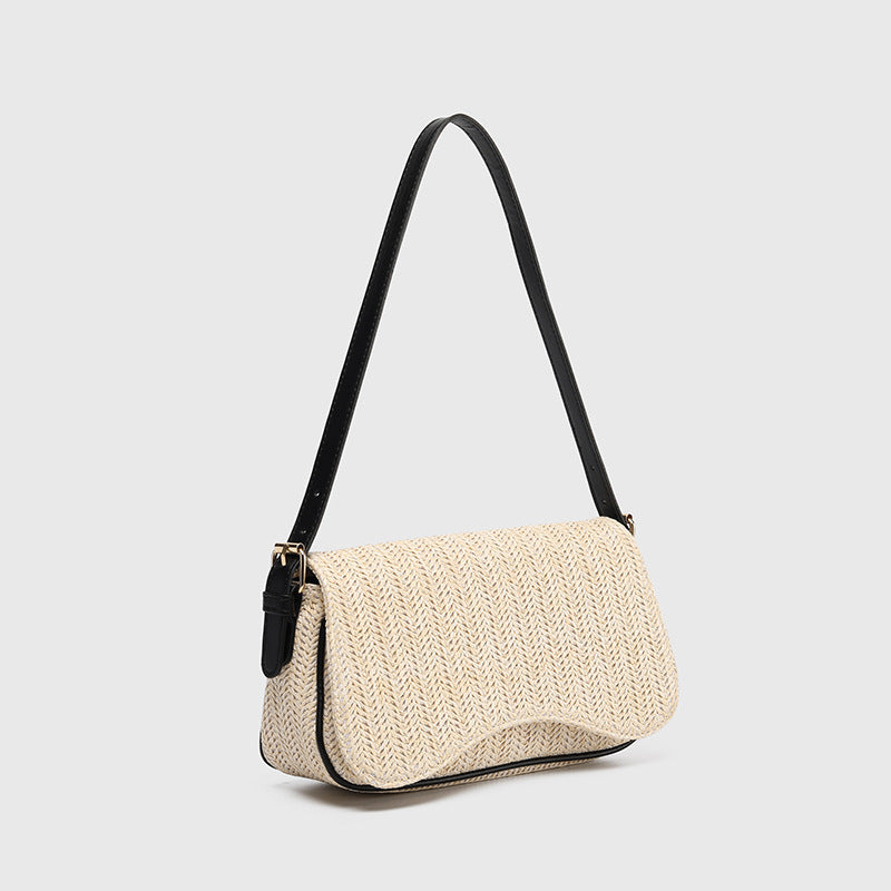 Beige woven handbag with black strap on a light gray background