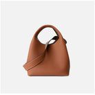 Brown leather handbag on a light gray background