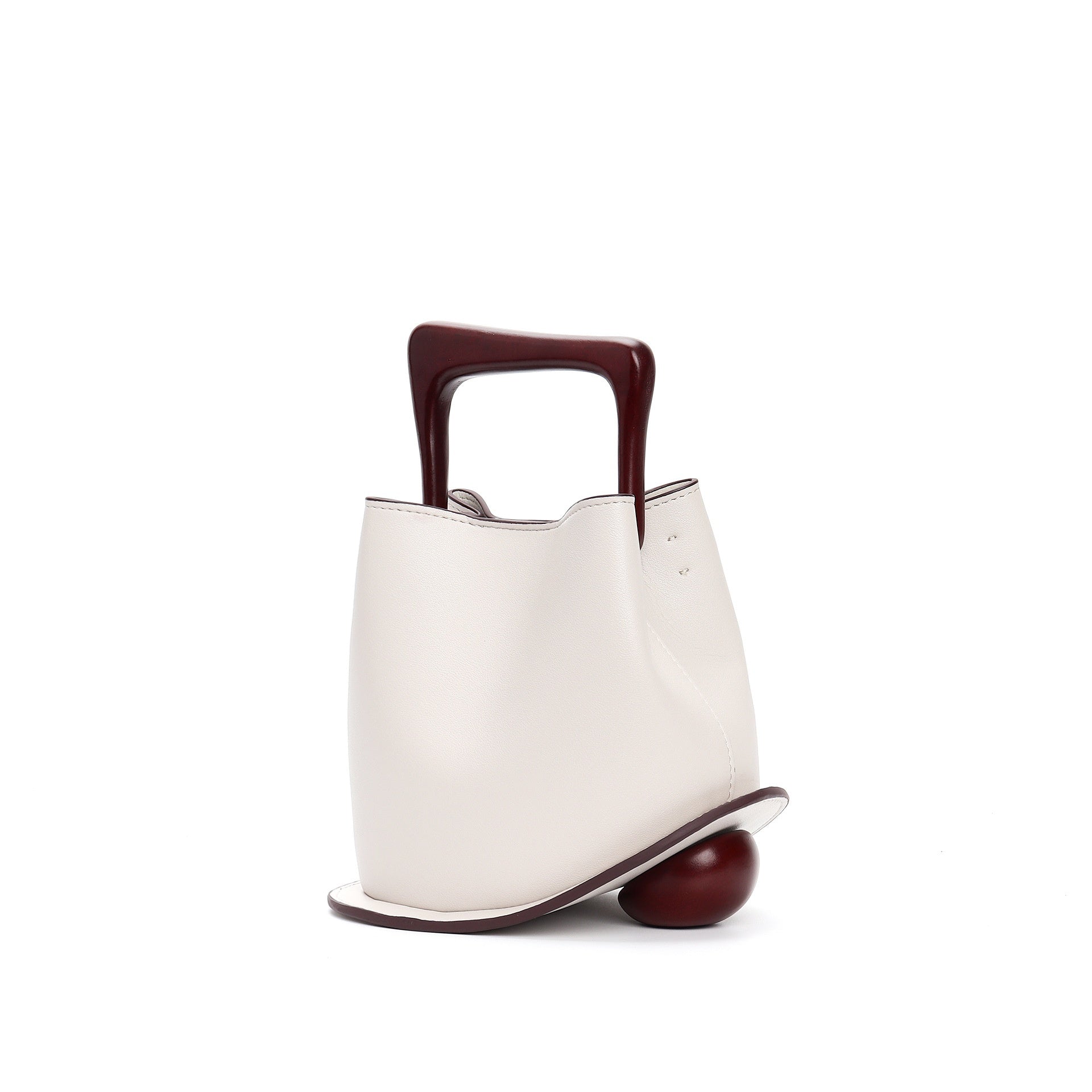 White handbag with a brown handle and base on a white background