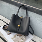 Black handbag on a magazine with a blurred background