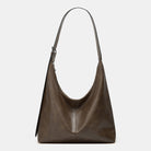 Brown leather handbag on a light gray background