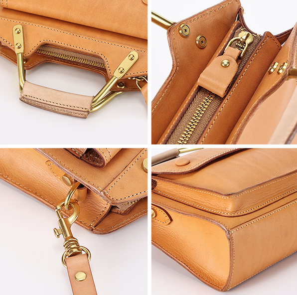 Close-up of a tan leather handbag with gold hardware on a white background