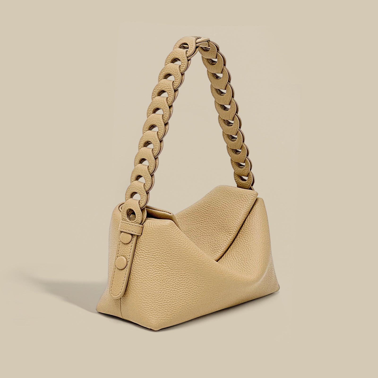 Beige handbag with chain handle on a beige background