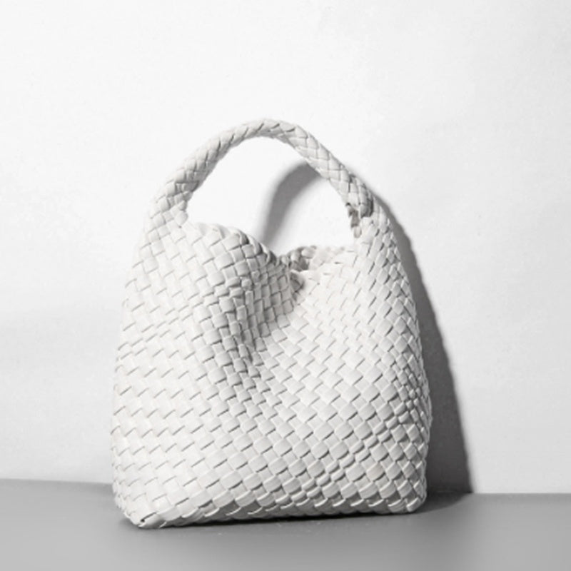 White woven handbag on a light gray background