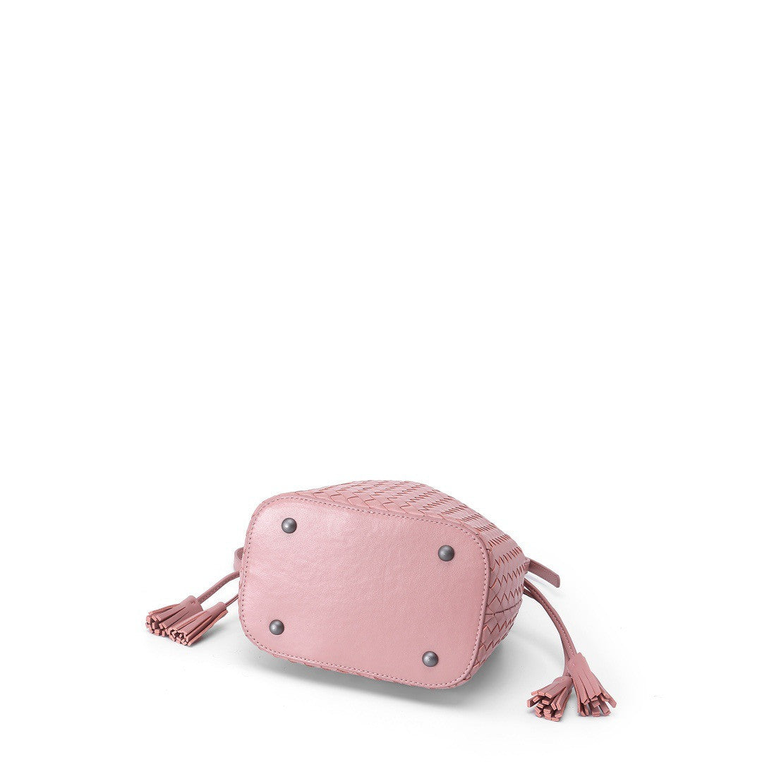 Pink textured handbag with tassels on a white background