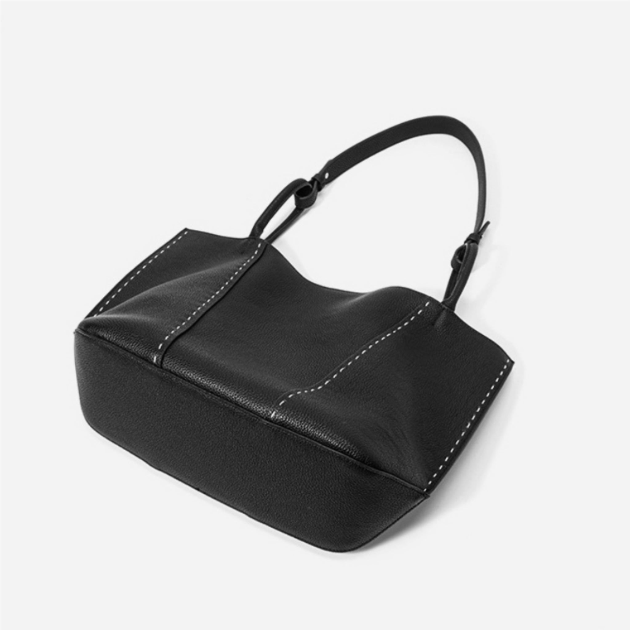 Black handbag on a light gray background