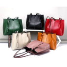 Collection of colorful leather handbags on a white background