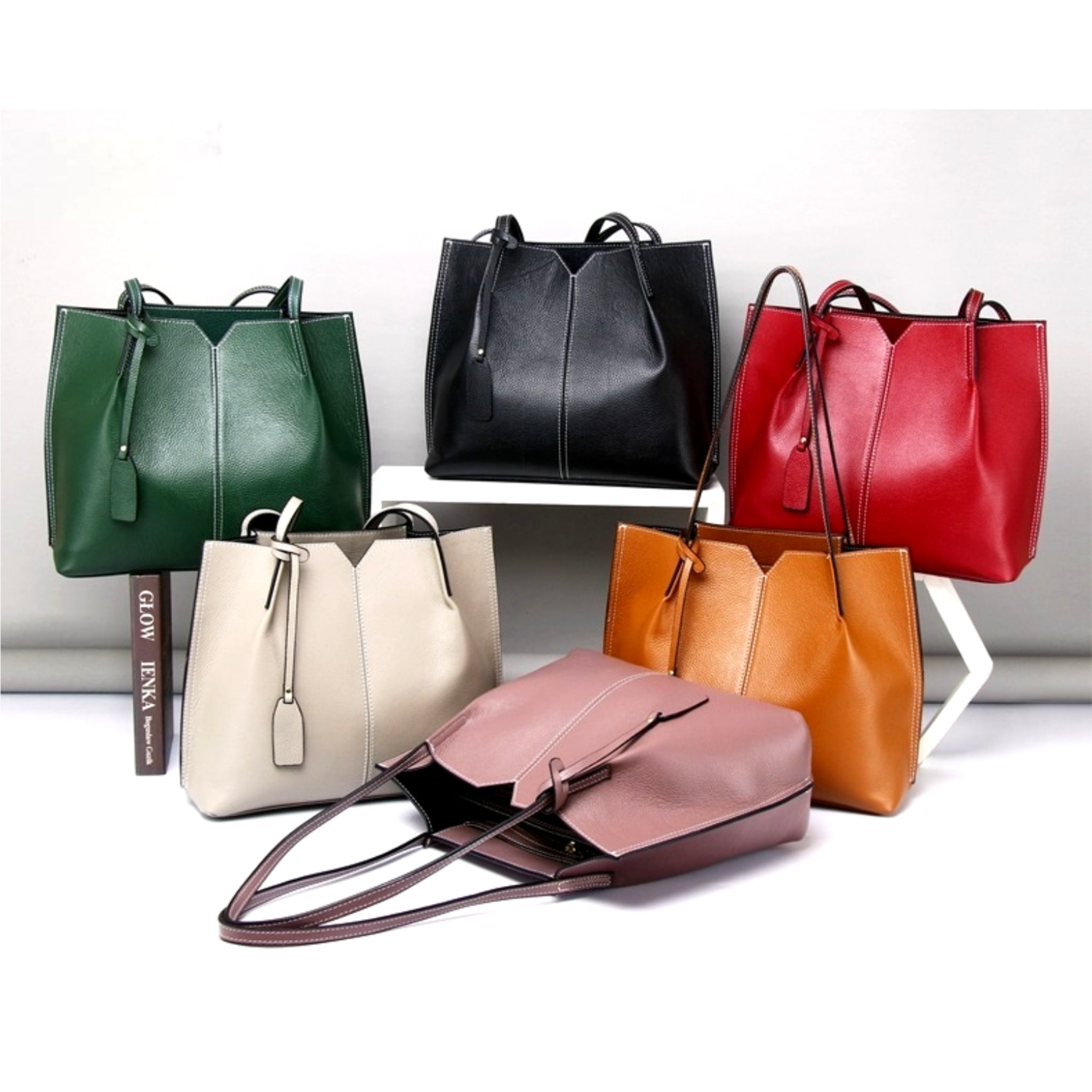 Collection of colorful leather handbags on a white background