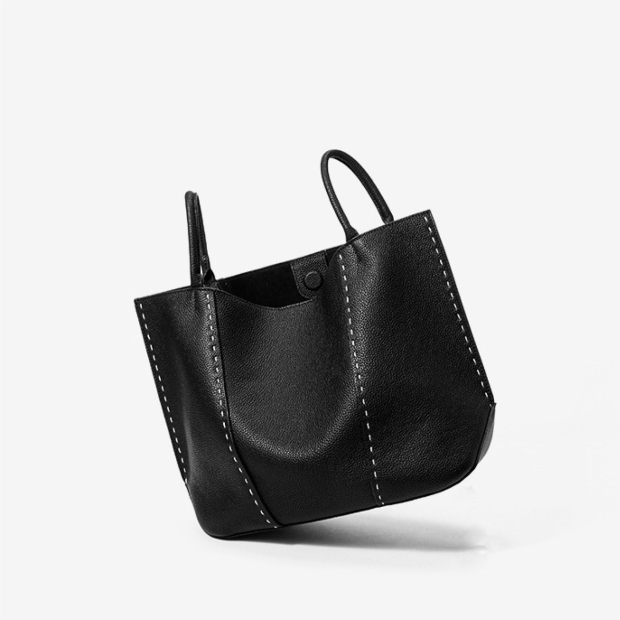 Black leather handbag on a white background