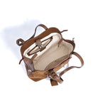 Brown leather handbag with beige interior on a white background