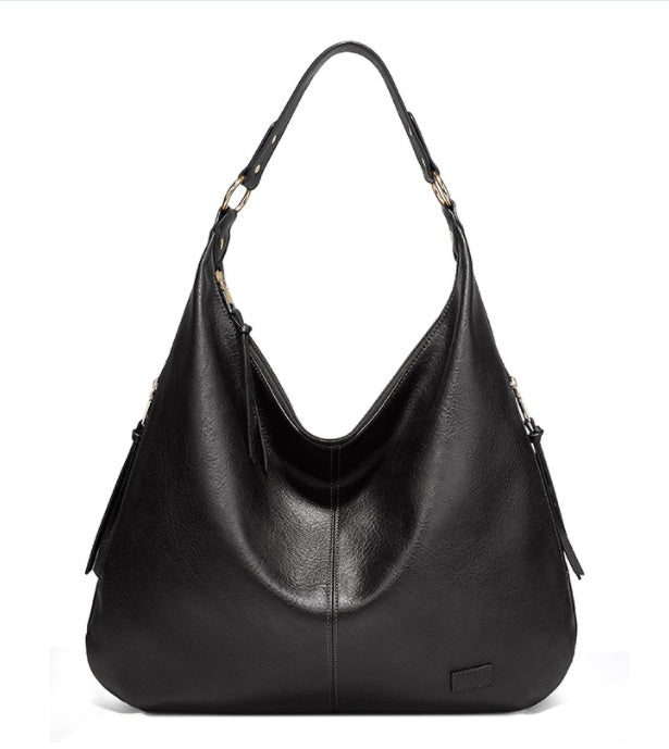 Black leather handbag on a white background