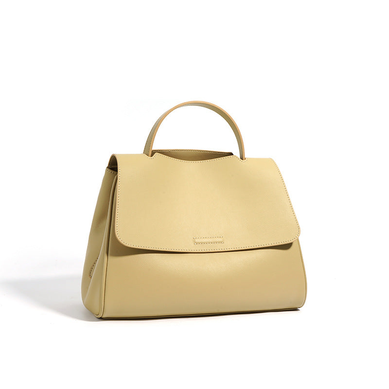 Yellow handbag with a visible brand logo on a white background