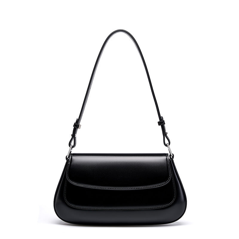 Black handbag with a strap on a white background
