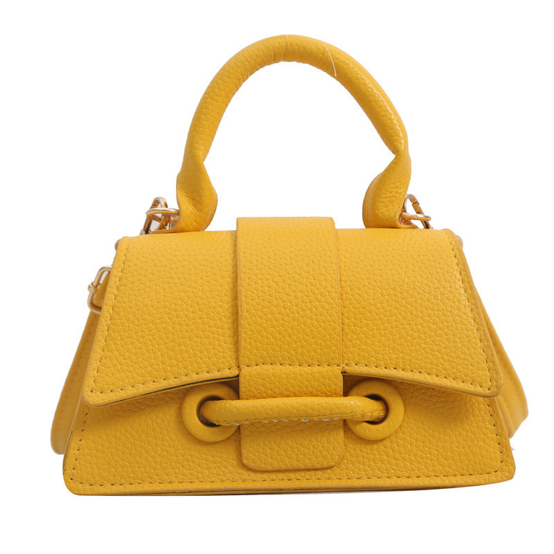Yellow handbag with a prominent handle on a white background