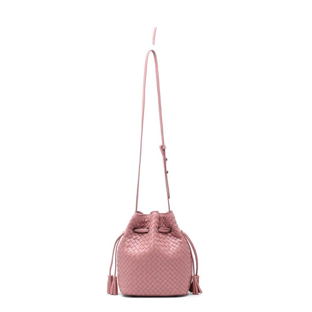 Pink woven drawstring bag on a white background