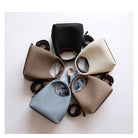Five different colored handbags arranged on a white surface.