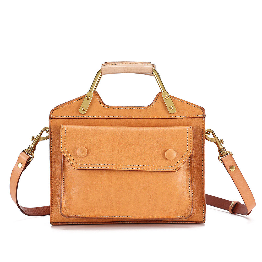 Tan leather handbag with gold accents on a white background