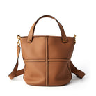 Brown leather handbag with a shoulder strap on a white background