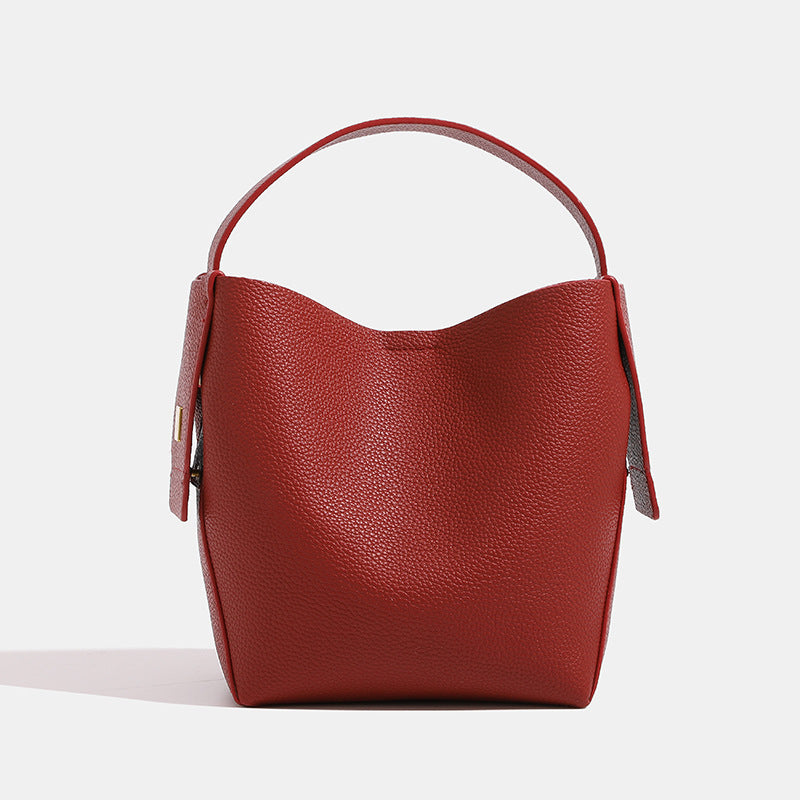 Red leather handbag on a light gray background