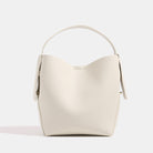 Beige handbag with a strap on a white background