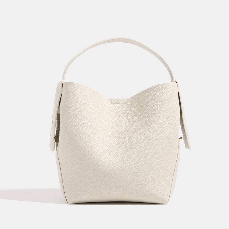 Beige handbag with a strap on a white background
