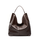 Brown leather handbag on a white background
